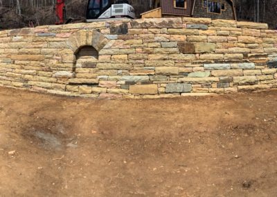 large retaining wall with arched alcove