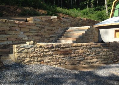 large stone retaining wall with stone staircase